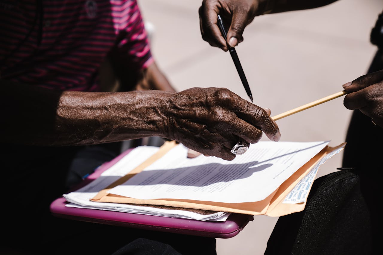 Services Close-up of hands exchanging documents with pens outdoors. Business agreement concept.