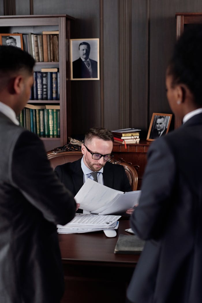 Home Business professionals discussing important legal documents in an office setting.