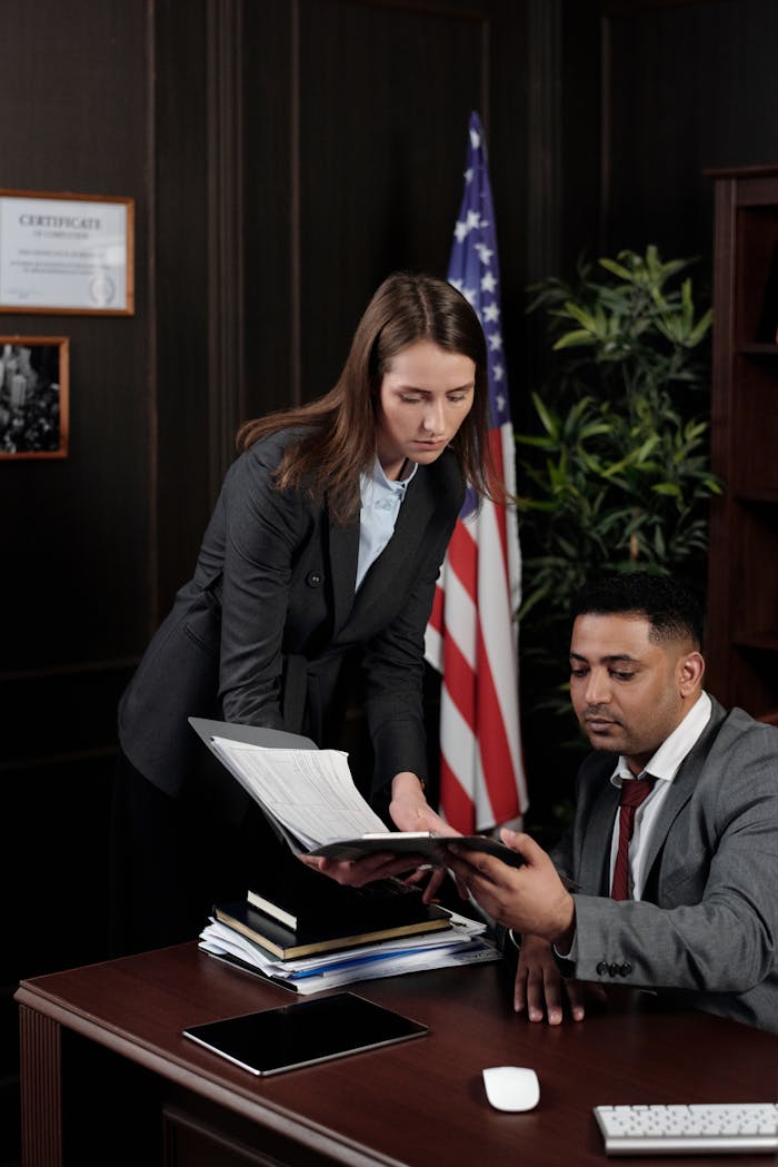 Services Business professionals discussing documents in a US-themed office setting.