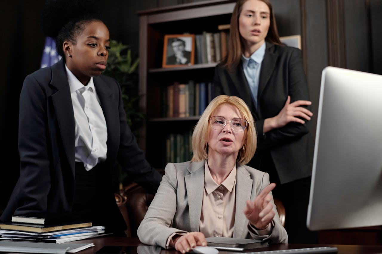 About A group of diverse businesswomen collaborating in a modern office setting, discussing work strategies.